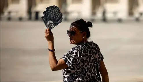  ?? ?? A woman uses a fan in the courtyard of the Louvre museum, September 2023, in Paris.