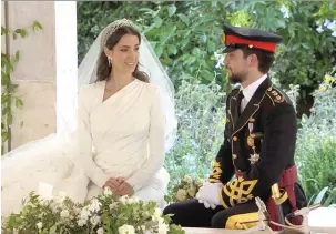  ?? (Royal Hashemite Court (RHC)/Handout via Reuters) ?? JORDAN’S CROWN PRINCE Hussein and his bride, second cousin Rajwa Al Saif, enjoy a quiet moment together after their royal wedding ceremony in Amman yesterday.