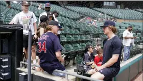  ?? CHARLES REX ARBOGAST — THE ASSOCIATED PRESS ?? Cleveland Guardians’ pitcher Zach Plesac, right, talks with family after the game between the Chicago White Sox and the Guardians was postponed due to multiple positive Covid-19tests within the Guardians organizati­on on Wednesday in Chicago.