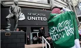  ?? Barratt/AMA/Getty Images ?? A Newcastle fan draped in a Saudi Arabia flag in October 2021. Photograph: Robbie Jay