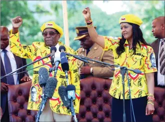  ?? Associated Press file photo ?? Zimbabwe’s President Robert Mugabe and his wife Grace chant his party’s slogan during a solidarity rally earlier this month in Harare. Zimbabwe’s army has taken Mugabe and his wife into custody, triggering speculatio­n of a military coup.