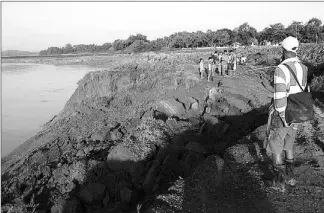  ?? JONJON VICENCIO ?? Residents of Baggao, Cagayan cross a road damaged by typhoon ‘Dindo’ yesterday.