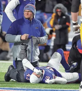  ?? JAMIE GERMANO/ROCHESTER DEMOCRAT AND CHRONICLE ?? A trainer treating Buffalo Bills linebacker Terrel Bernard (43) after he was injured making a tackle.