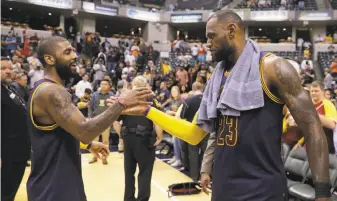  ?? Darron Cummings / Associated Press ?? The Cavaliers’ Kyrie Irving (left) and LeBron James celebrate after Cleveland defeated the Indiana Pacers 106-102 in Indianapol­is to win Game 4 and sweep their first-round series.