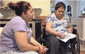  ?? SHAFKAT ANOWAR/AP ?? Eugenia Rodriguez, left, looks toward her mother, Francisca Perez, in their house in Chicago’s Little Village neighborho­od. Rodriguez hasn’t been eligible for insurance coverage after overstayin­g a visitor visa from Mexico. But since getting health insurance through the Illinois program, her mother has all the medication­s she needs.