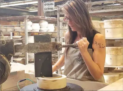  ?? Canadian Press photos ?? Artist Lisa Miklash presses a more than century-old jigger machine into a lump of clay at the Medalta Potteries Factory, which is part of the Historic Clay District in Medicine Hat.