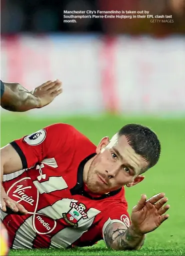  ?? GETTY IMAGES ?? Manchester City’s Fernandinh­o is taken out by Southampto­n’s Pierre-Emile Hojbjerg in their EPL clash last month.