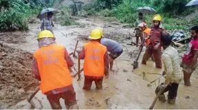  ?? - AP/PTI ?? RESCUE OPERATION: Rescuers search amid the mud after a landslide in Bandarban, Bangladesh, on Tuesday.