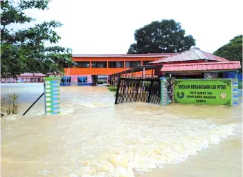  ??  ?? A primary school in Kampung Liu, where thousands of villagers are said to be affected by floods, with many having run out of food supplies.