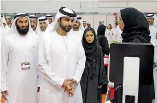  ?? Photos by Juidin Bernarrd ?? UAE jobseekers are seen at a pavilion during Careers UAE 2018 that opened at the Dubai World Trade Centre on Tuesday. Below, Sheikh Mansoor bin Mohammed bin Rashid Al Maktoum is briefed after the opening of the career fair. —