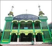  ?? ANGGER BONDAN/JAWA POS ?? DOMINASI HIJAU: Menara Masjid Al Hikmah di Raya Tebel yang dicat dengan kombinasi menarik empat warna.