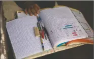  ??  ?? Oscar readies his notebooks, pens and pencils, as he prepares for the arrival of Ixcoy.