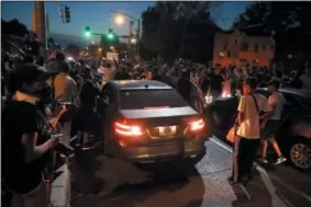  ??  ?? Protesters surround a car as they march in the street response to a not guilty verdict in the trial of former St. Louis police officer Jason Stockley Saturday, Sept. 16, 2017, in St. Louis. Stockley was acquitted in the 2011 killing of a black man...