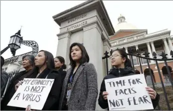  ?? AP PHOTO/STEVEN SENNE ?? In this March 12, 2020, file photo, Jessica Wong, front left, Jenny Chiang, center, and Sheila Vo, from the state’s Asian American Commission, stand together during a protest on the steps of the Statehouse in Boston. With a virtual event scheduled for Tuesday.
