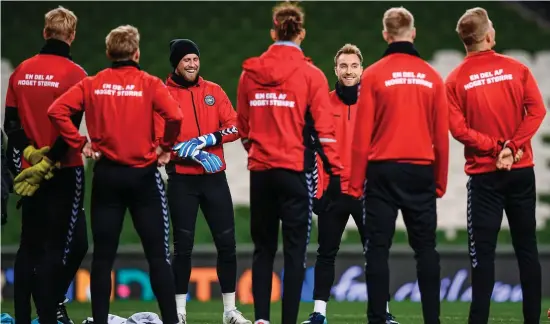  ?? STEPHEN McCARTHY/SPORTSFILE ?? Kasper Schmeichel and Christian Eriksen share a joke with their Danish team-mates during training at the Aviva Stadium last night