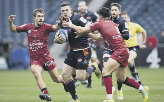  ??  ?? 2 Centre Matt Scott, who was an influentia­l figure in Edinburgh’s thumping win over Toulon on Saturday, breaks past Anthony Belleau.