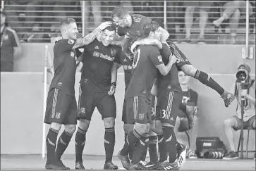  ?? Marcio Jose Sanchez Associated Press ?? CHRISTIAN RAMIREZ, second from left, is mobbed by LAFC teammates after scoring in the first half.