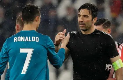  ?? AP PHOTO ?? WELL PLAYED, BROTHER: Juventus goalkeeper and captain Gianluigi Buffon, right, shakes hands with Real Madrid’s Cristiano Ronaldo. Buffon has announced he is leaving the Italian champions but the goalkeeper could continue playing elsewhere.