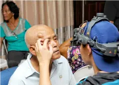  ??  ?? A villager undergoes an eye screening during the RCMOT medical mission.