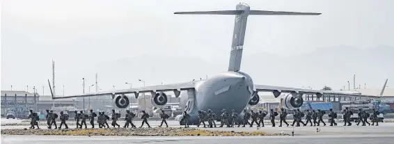  ?? SENIOR AIRMAN TAYLOR CRUL, U.S. AIR FORCE VIA AP ?? Soldiers assigned to the 82nd Airborne Division arrive to provide evacuation security in support of Operation Allies Refuge at Hamid Karzai Internatio­nal Airport in Kabul, Afghanista­n, on Friday. The airport remained a scene of chaos on Saturday and threats were changing rapidly, U.S. officials said.