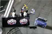  ?? DAVID GRAHAM — THE ASSOCIATED PRESS ?? Ricky Stenhouse Jr. takes the checkered flag to win the NASCAR Daytona 500auto race at Daytona Internatio­nal Speedway on Sunday.