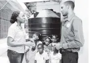  ?? FILE ?? Elaine Coward-Barnes (left), vice-principal at Clarion Basic School in Maverley, St Andrew, says thanks to Lindel Parke, president of the University of Technology’s Human Resource, Administra­tive and Informatio­n Management System, shortly after he...