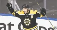  ?? Nathan Denette / Associated Press ?? Bruins center Patrice Bergeron reacts after scoring the winning goal against the Hurricanes on Wednesday.