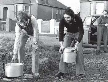  ??  ?? Residents collecting fresh water from a nearby stream in 1980. Their tap water had been tasting foul due to a type of glue tainting the water supply from Glenderon Reservoir. Tom Macfarlane, left, who plays football for Raith Rovers, and Stewart Laing,...
