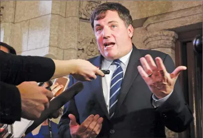  ?? CP PHOTO ?? Dominic LeBlanc talks to reporters outside the House of Commons in Ottawa, on Wednesday. LeBlanc has been diagnosed with leukemia, but says he’s confident that won’t get in the way of his work as federal fisheries minister.