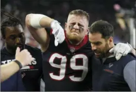  ?? ERIC CHRISTIAN SMITH — ASSOCIATED PRESS ?? Texans defensive end J.J. Watt is helped off the field after an injury during the first half of an NFL football game Sunday in Houston.