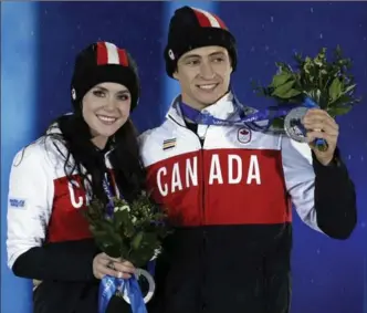  ?? ASSOCIATED PRESS FILE PHOTO ?? Tessa Virtue and Scott Moir of Canada pose with the silver medals they earned at the 2014 Winter Olympics in Sochi, Russia. “We’re right on track with where we want to be in our Olympic plan,” Virtue said.