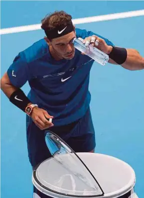  ?? AFP PIC ?? Rafael Nadal washes his eye with water during his quarter-final match against John Isner at the China Open yesterday.