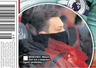  ??  ?? BENCHED: Mesut Ozil cut a dejected figure yesterday