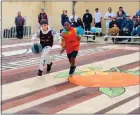  ?? COURTESY PHOTO ?? Phillip Cervantes, left, and Casen Merenu play basketball March 5 at the Casa Blanca Home of Neighborly Service in Riverside. An event that day unveiled a new mural on the renovated basketball court.