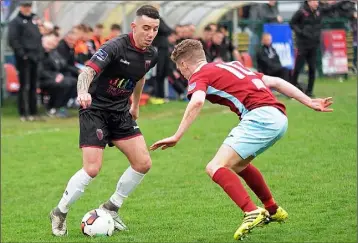  ??  ?? Wexford right back Ricky Fox takes on Ian Mylod of Cobh Ramblers (Photograph­s: George Hatchell).