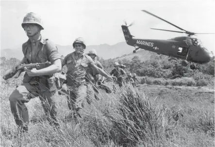  ?? Associated Press photo by Eddie Adams ?? n Marine infantry stream into a suspected Viet Cong village April 28, 1965, near Da Nang in Vietnam. Filmmaker Ken Burns said he hopes his 10-part documentar­y about the War, which begins Sept. 17 on PBS, could serve as a sort of a vaccine against some...