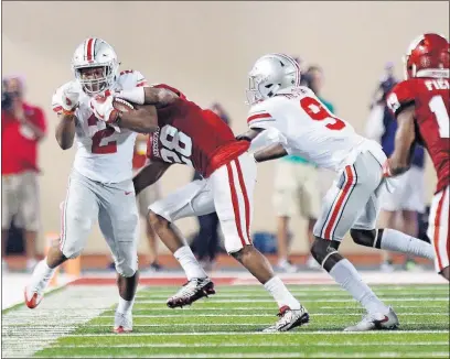  ?? [ADAM CAIRNS/DISPATCH] ?? Ohio State running back J.K. Dobbins tiptoes along the sideline as he his hit by A’Shon Riggins of Indiana during the third quarter.