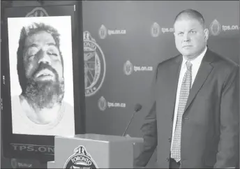  ?? CP PHOTO ?? Det. Hank Idsinga, lead investigat­or in the case against alleged serial killer Bruce McArthur, stands with a photo of an unidentifi­ed man, suspected of being another of McArthur’s victims, during a news conference at Toronto Police headquarte­rs.