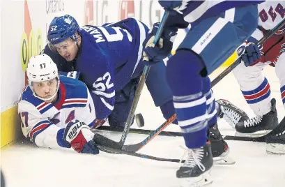  ?? STEVE RUSSELL TORONTO STAR ?? Rangers right wing Jesper Fast is tied up by Leafs defenseman Martin Marincin on Saturday at the Scotiabank Arena.