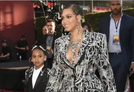  ?? PHOTO BY CHRIS PIZZELLO — INVISION — AP ?? Beyonce, a cast member in “The Lion King,” arrives with her daughter Blue Ivy at the premiere of the film, Tuesday in Los Angeles.