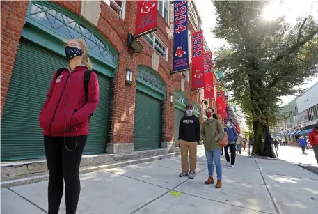  ?? STuART cAHiLL PHoTos / HeRALd sTAFF ?? GET YOUR BALLOTS HERE! Voters line up around the block as early voting begins at Fenway Park on Saturday.