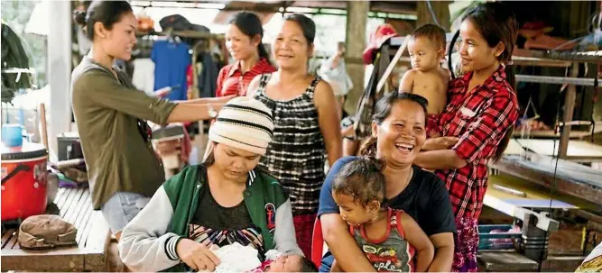  ??  ?? Phnom Penhbased cofounder Nita Pennell, left, regularly visits the weavers to buy kramas to be shipped to New Zealand.