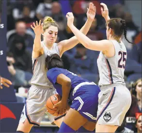  ?? Stephen Dunn / Associated Press ?? UConn’s Katie Lou Samuelson, left, and Kyla Irwin (25) double team Seton Hall’s Femi Funeus during Saturday’s game in Hartford.