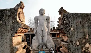  ?? — PTI ?? A view of the Gomateshwa­ra statue of Shravanabe­lagola in Karnataka. A scaffoldin­g and visitors’ gallery are being constructe­d near the statue by using the German technology of ring- and- lock, to facilitate the anointment during Mahamastak­abhisheka....