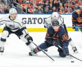  ?? POSTMEDIA NEWS ?? Edmonton Oilers’ Ryan Nugent-hopkins battles L.A. Kings’ Brendan Lemieux (right) and Matt Roy during first period NHL action in Game 2 of their first-round Stanley Cup playoff series in Edmonton on May 4.