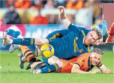  ?? ?? Aberdeen’s Marley Watkins and ex Don Peter Pawlett both end up on the floor