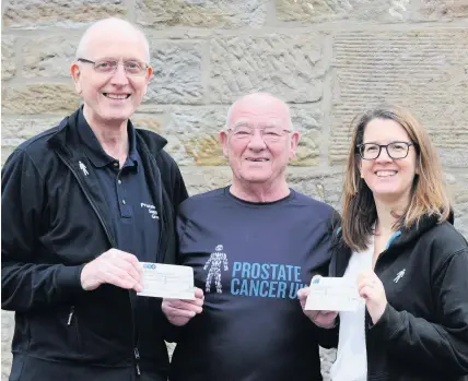  ??  ?? Handover
John presents cheques to charity representa­tives Charlie Hogg and Fiona Dunlop