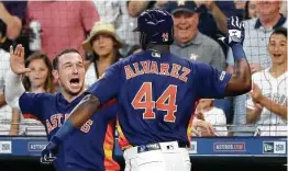  ??  ?? Alex Bregman was part of Sunday’s welcome wagon for Yordan Alvarez, who became the seventh Astro to hit a home run in his major league debut.