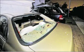  ?? PHOTOS BY LANNIS WATERS / THE PALM BEACH POST ?? Several cars in the Mirabella community of Palm Beach Gardens had body damage and broken windows, apparently from roof tiles, after storms passed over before dawn on Monday.
