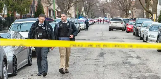  ?? TYLER LARIVIERE/SUN-TIMES ?? Chicago police investigat­e after an officer was shot in the shoulder Thursday in Brighton Park — according to police by a shoplifter who also wounded a Home Depot security guard before being killed in a shootout with the police. The officer was the fourth Chicago cop to be shot in two weeks.